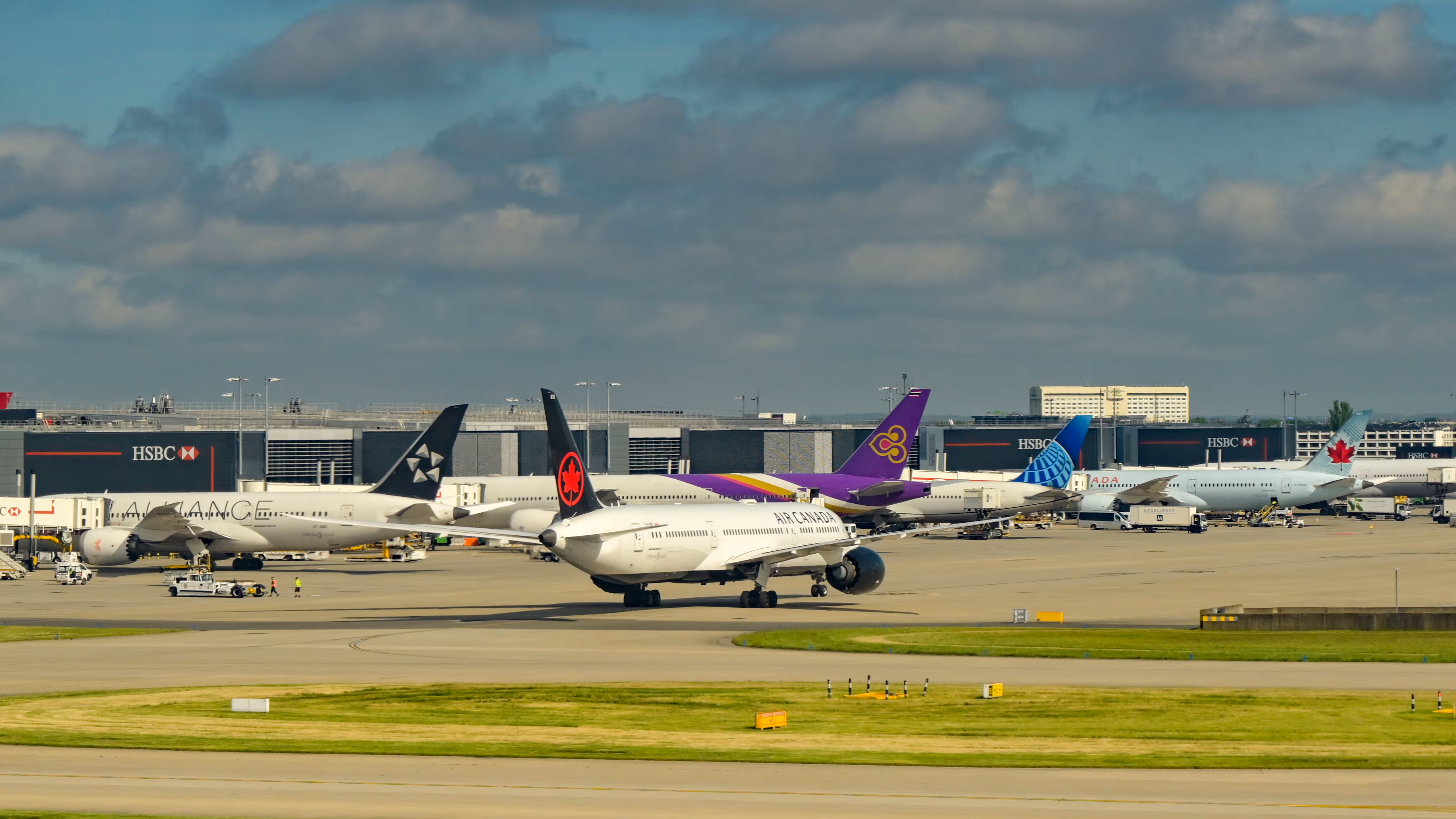 Busy airport ramp with commercial aircraft — AI traffic injection